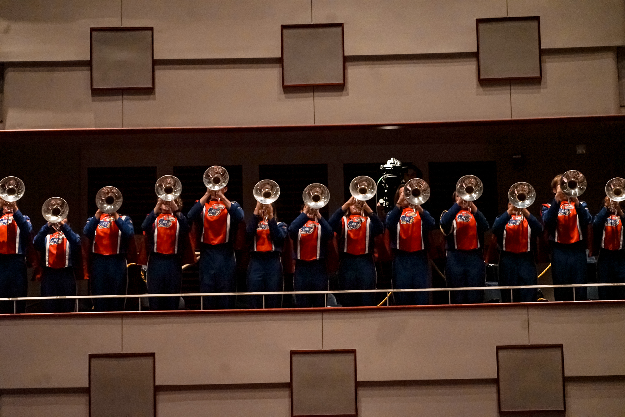 A group of students wearing marching band uniforms holding instruments.
