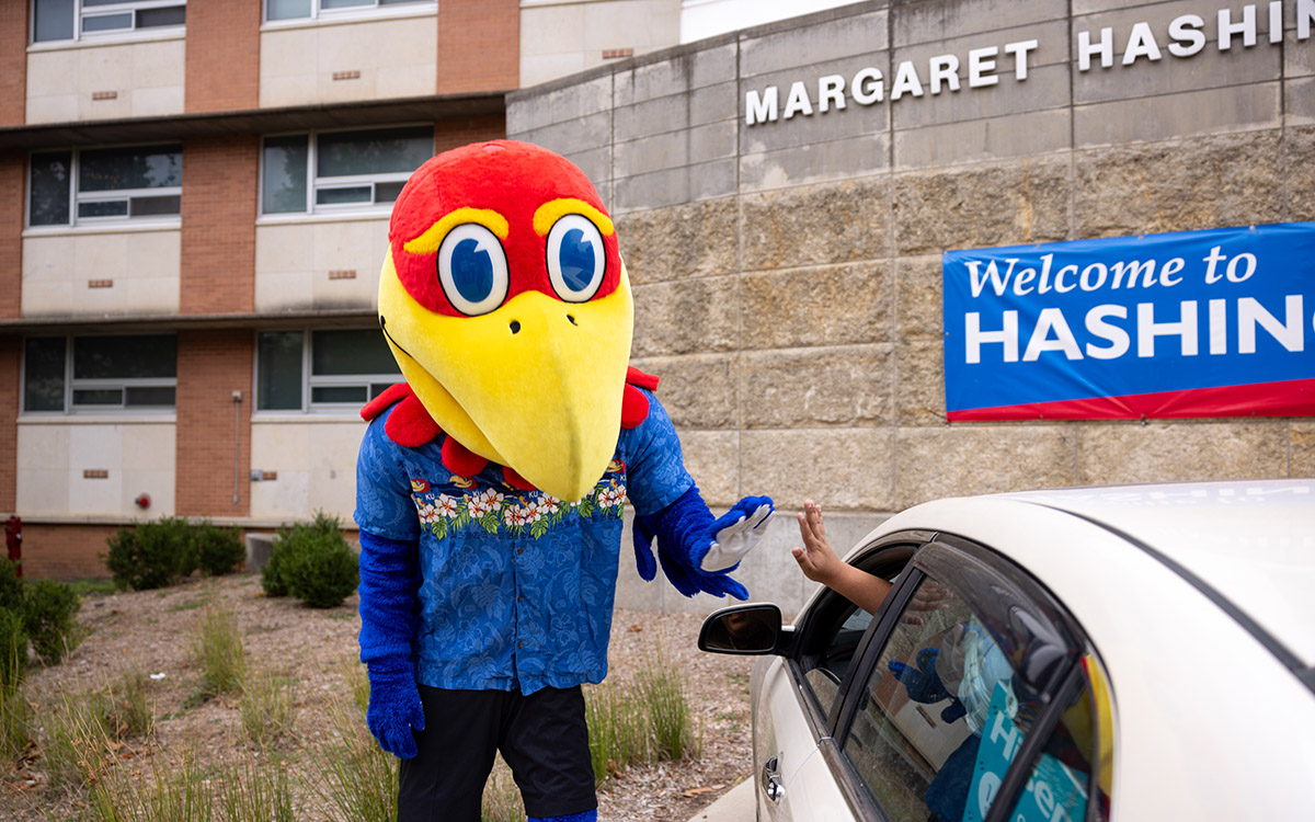 Big Jay high-fives a driver outside Hashinger Hall at the University of Kansas.