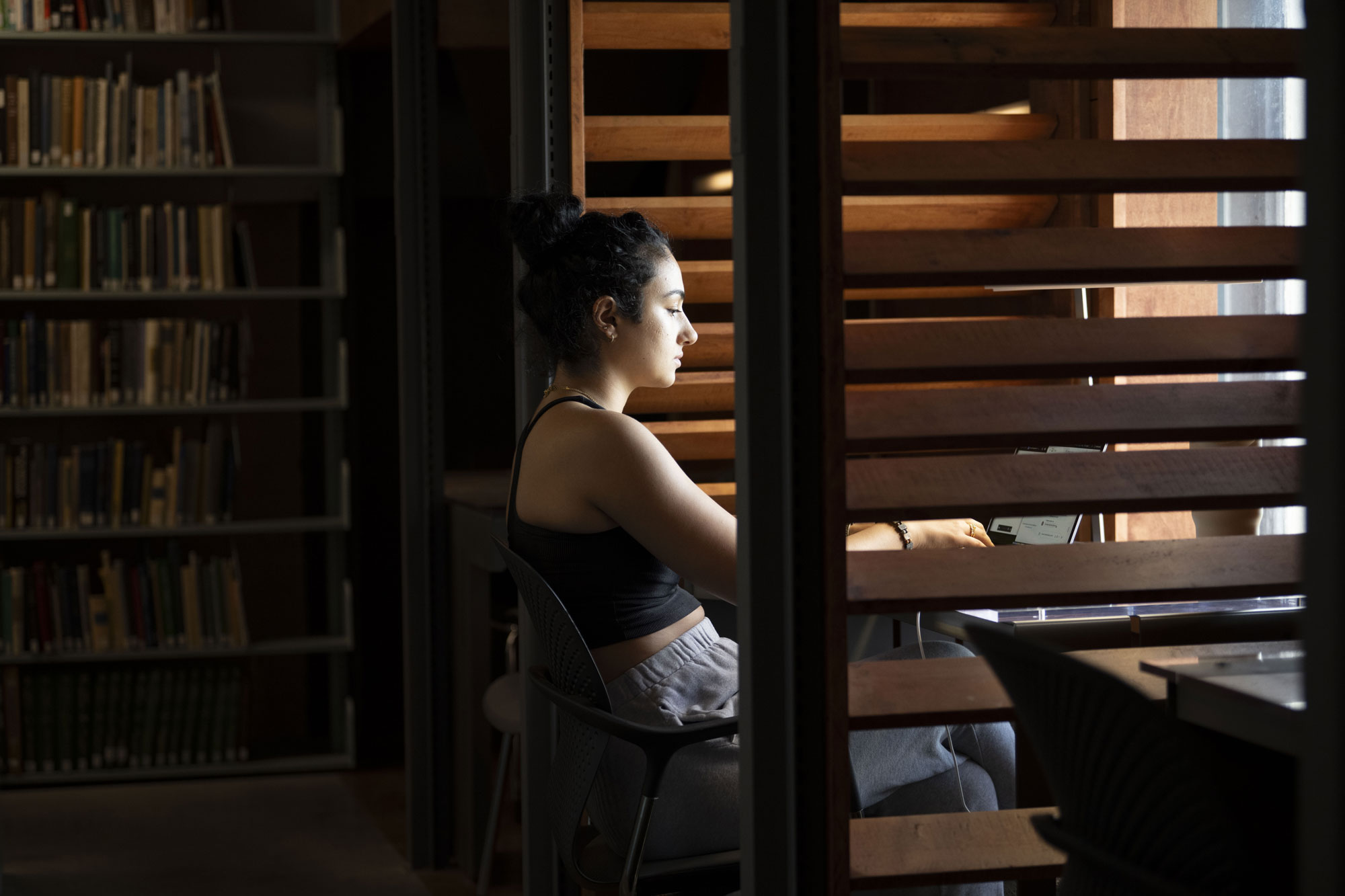 A student in the Watson Library stacks.