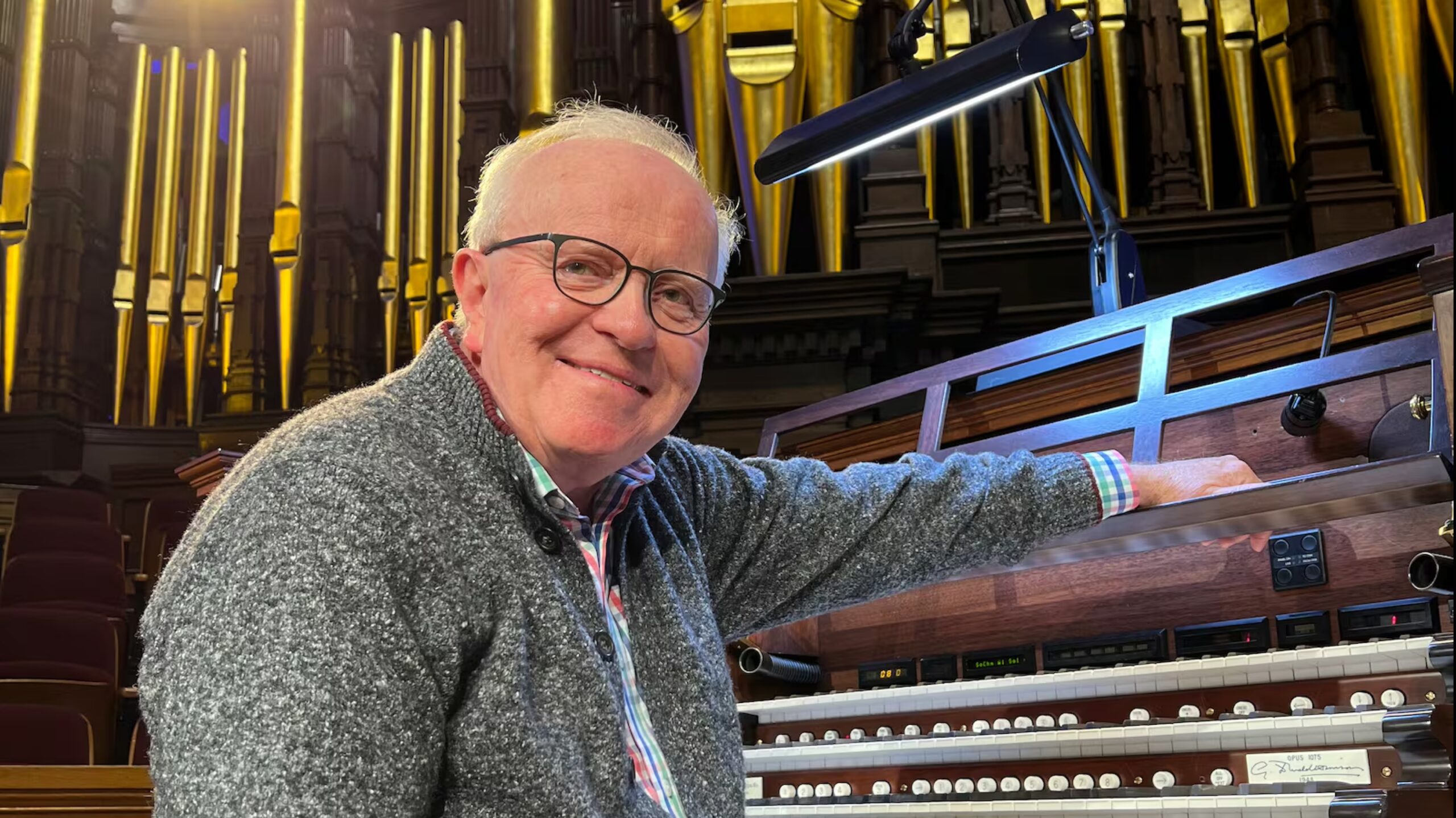 Dr. James Higdon seated at an organ