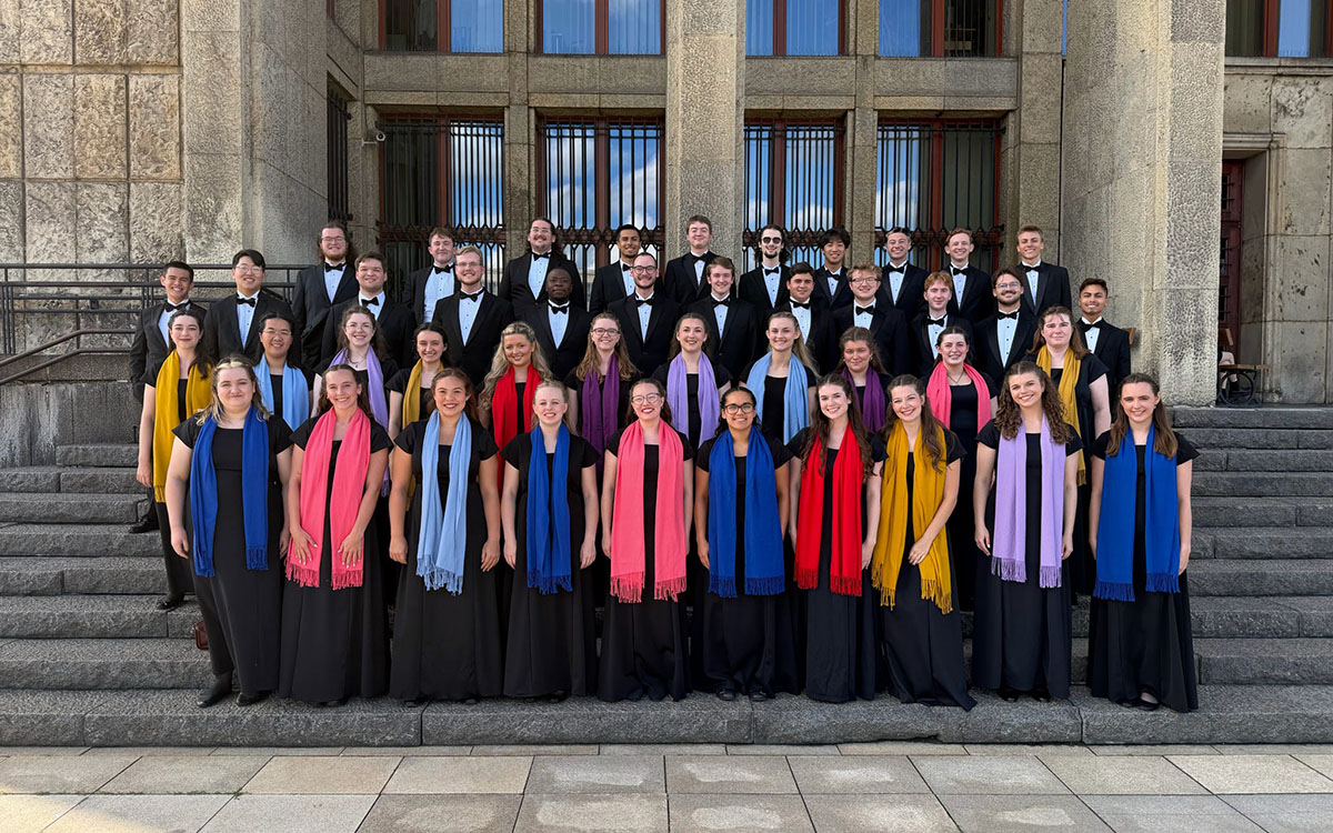 A group of musicians wearing robes standing on the stairs