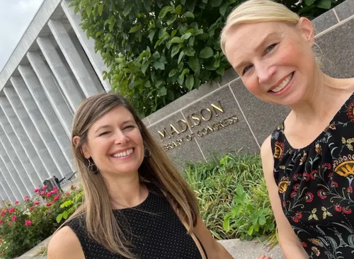 Two Life Span Institute researchers who are women stand in front of the Library of Congress for a photo