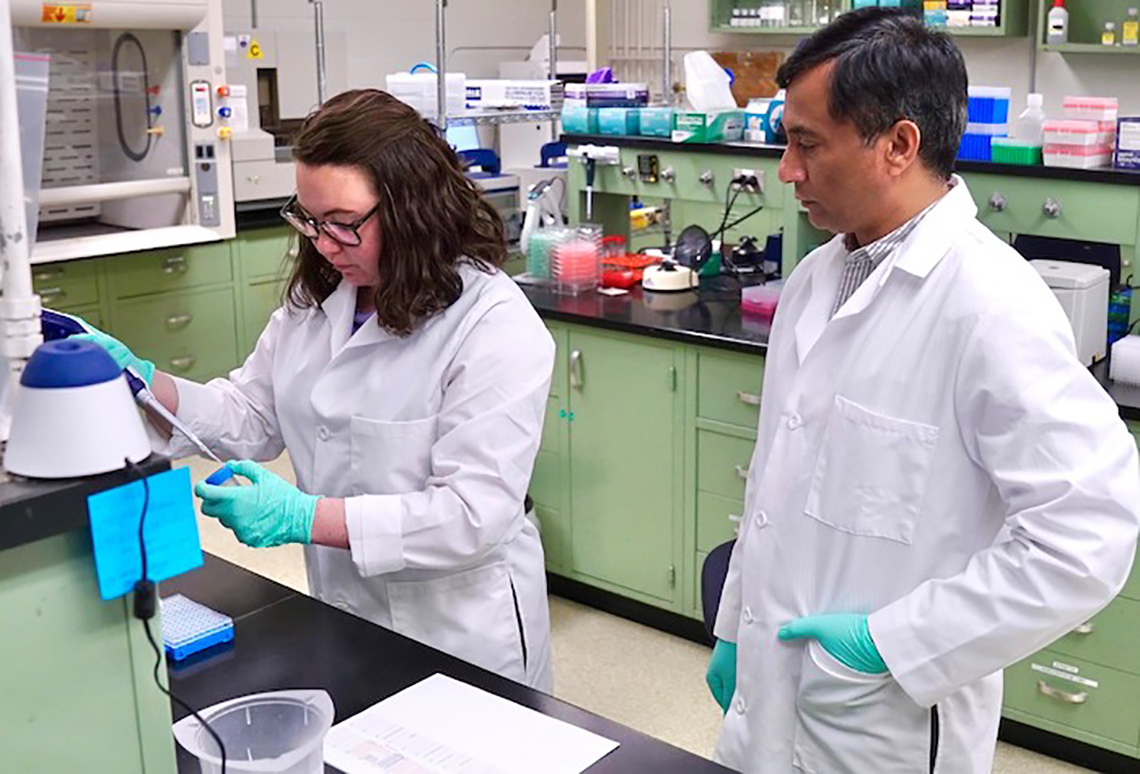 Erin Andres and M. Hashim Raza in the genetics laboratory