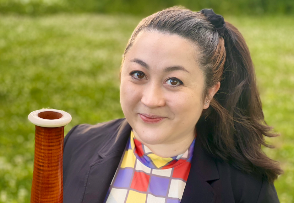 a woman posing with a bassoon