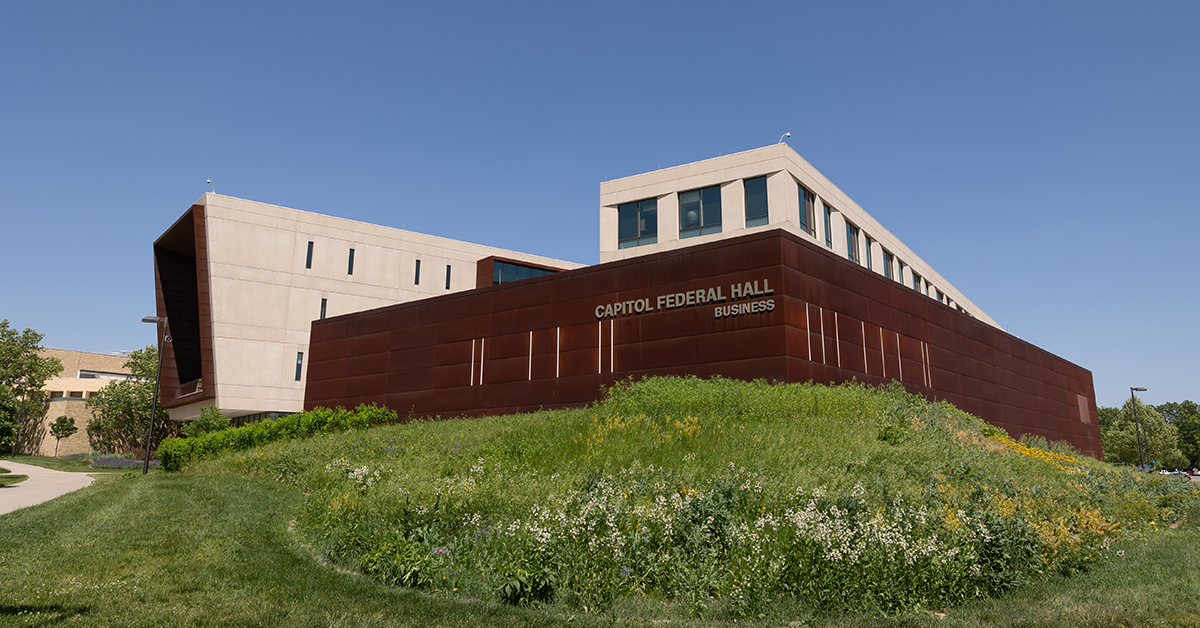 Photo of Capitol Federal Hall exterior with flowers in a butterfly garden in bloom in front of the building