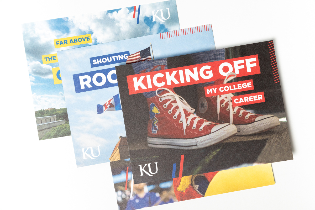 Studio photo of postcard mailers in a pile. The top postcard reads "Kicking off my college career" 