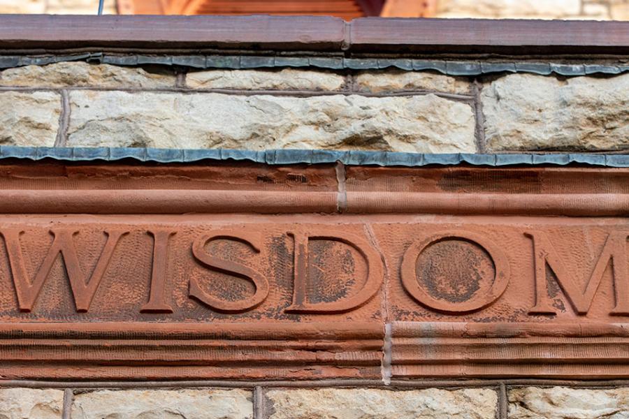"Wisdom" inscription on Spooner Hall building, home to The Commons