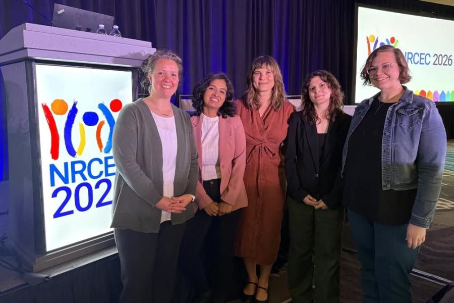 the team in front of the NRCEC conference presentation
