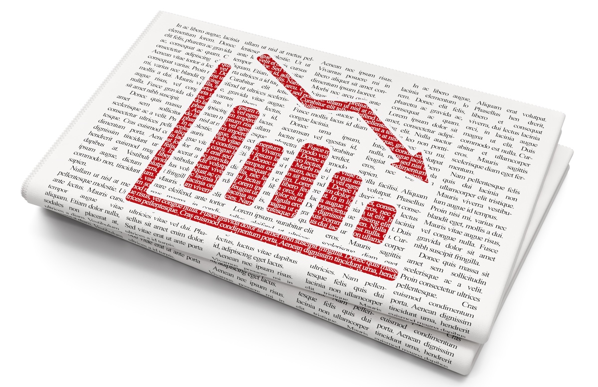 A newspaper displays the image of a bar graph that is showing a decline.