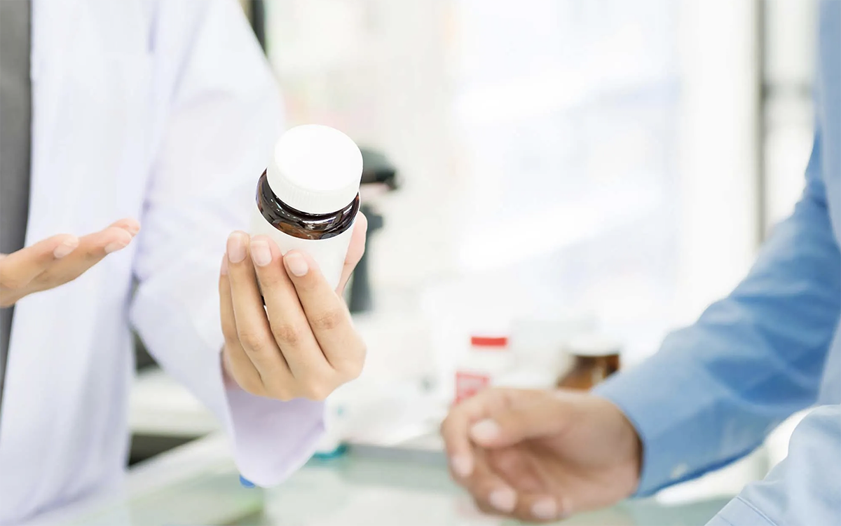 Stock photo of hands of pharmacist and customer during consultation
