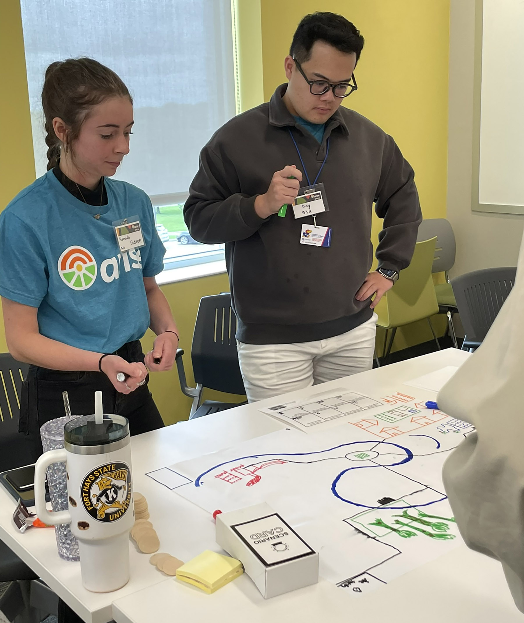 2 college students play tabletop game