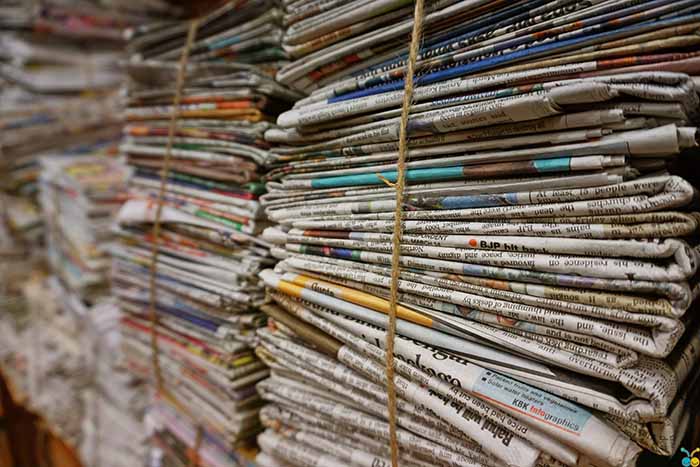 Photo of a stack of newspapers tied with a rope