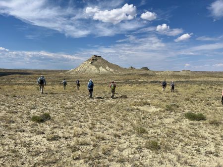 The Wyoming field crew walking toward a potential fossil locality