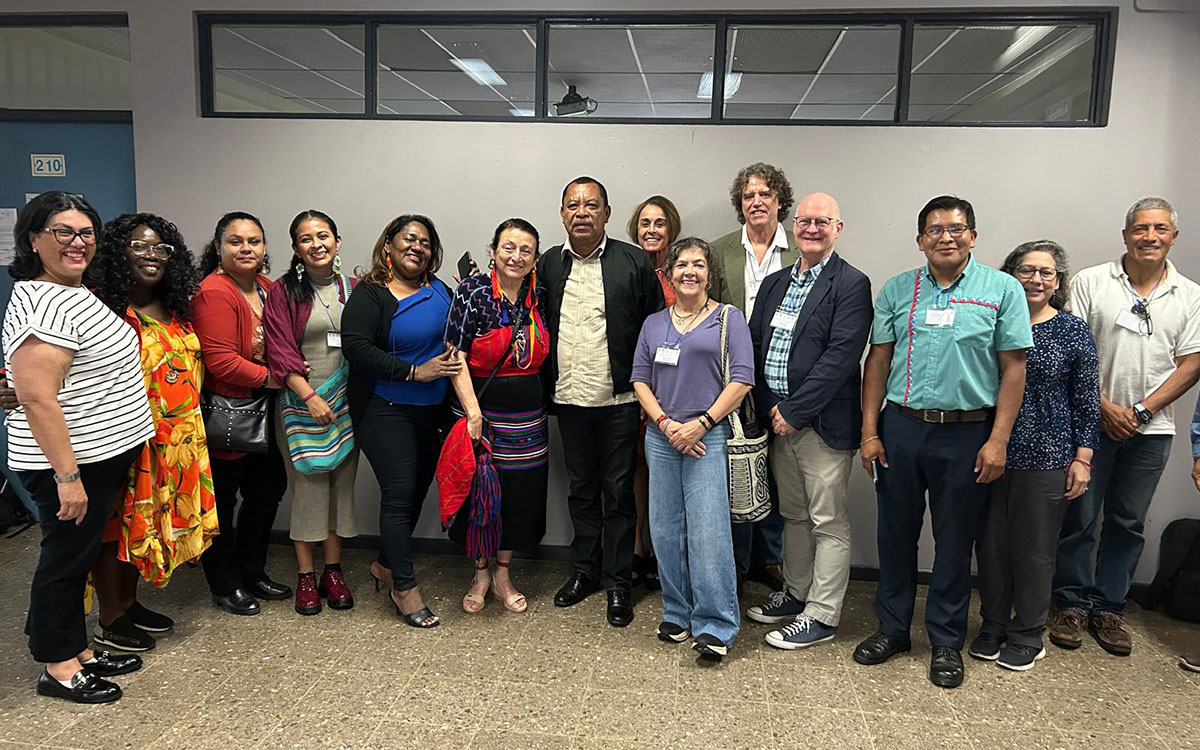 Group of scholars gather, standing and smiling, for photo at KU Center for Latin American & Caribbean Studies-hosted conference in Costa Rica.