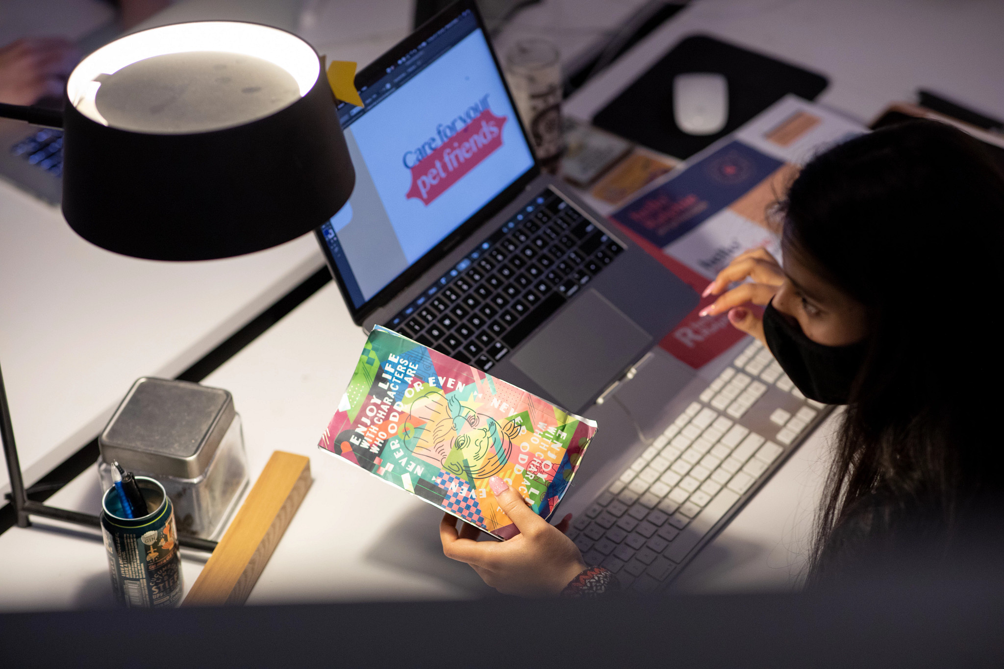 color photograph shows student working at laptop computer on design project