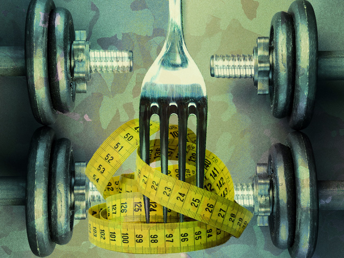 A large fork stabs at a ball of yellow measuring tape with dumbbell weights on either side to border the image against a transparent camouflage background 