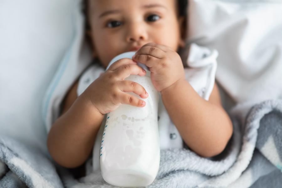 Stock photo of baby with bottle