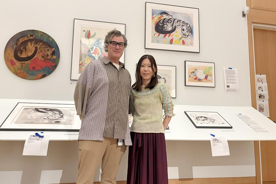Kris Ercums and Maki Kaneko in gallery with art behind them