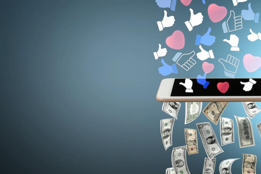 Images that represent approval of social media posts descend through a smart phone, where they’re converted into dollar bills.