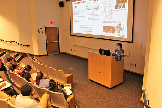 Dr. Maggie Witek talks about Coulter counters, which the group will make in the hands-on laboratory portion of the workshop.