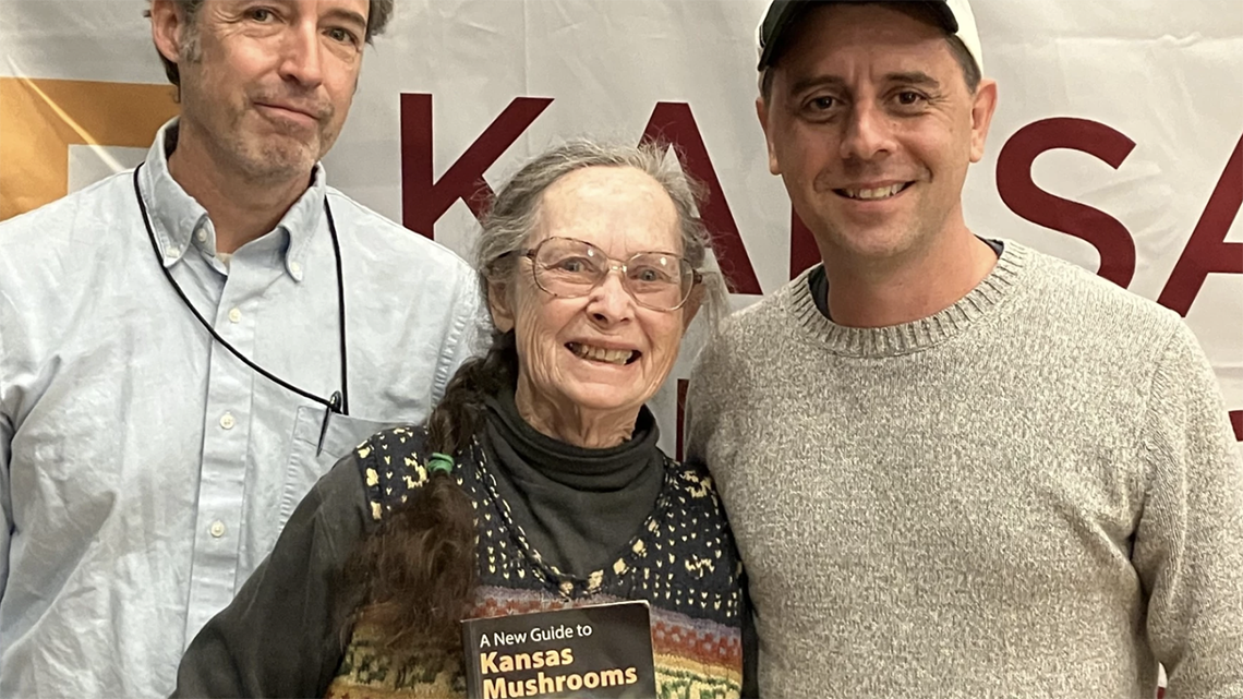 Authors hold new copy of Kansas Mushrooms book