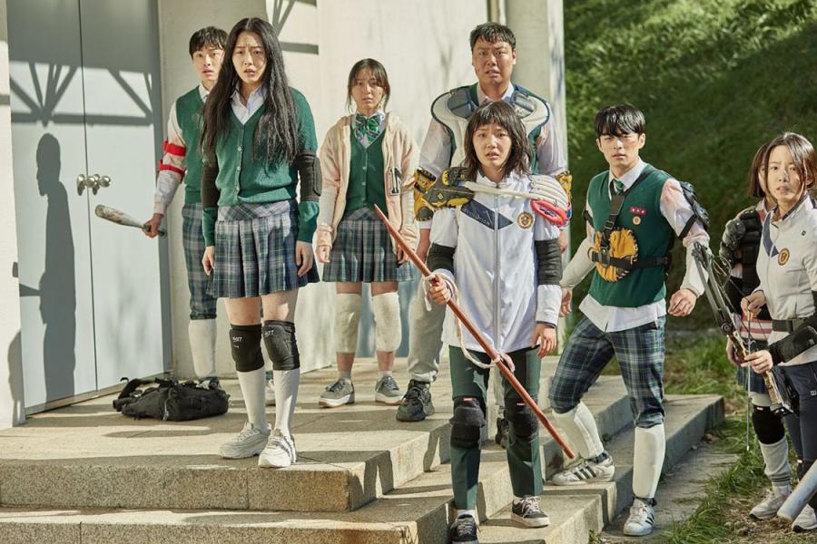 Eight young people in high school uniforms clutching weapons.