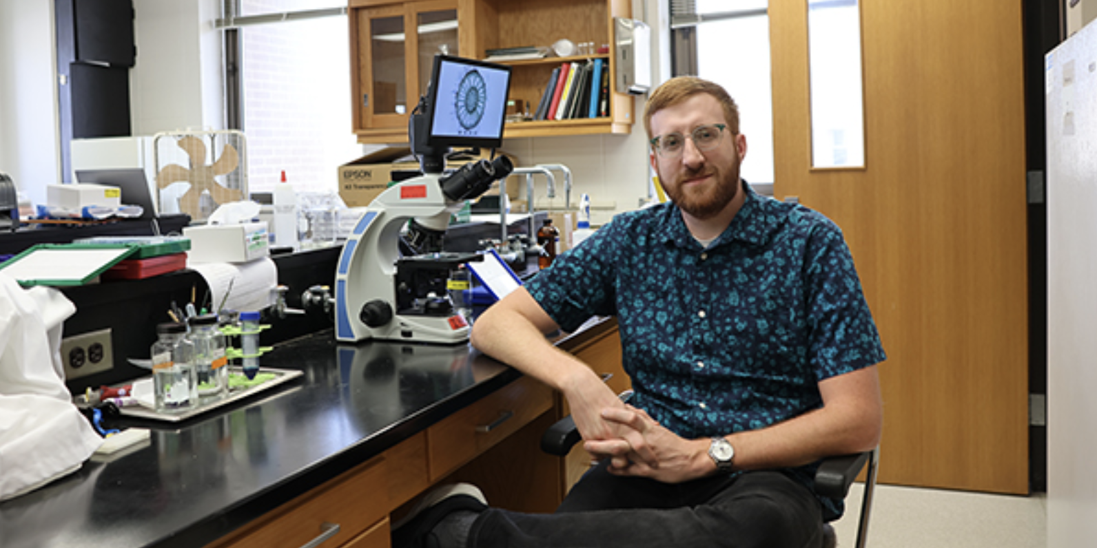 Person with beard and glasses in lab