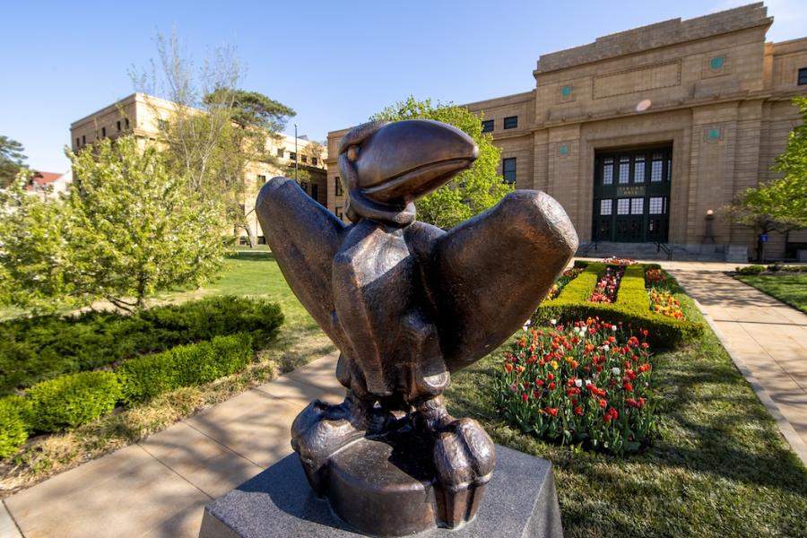 Academic Jay sculpture in front of Strong Hall during spring