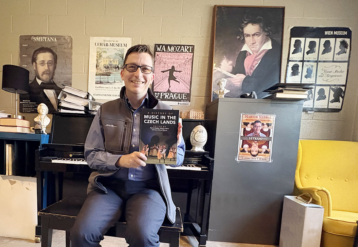 Martin Nedbal holding a copy of his book Music in the Czech Lands