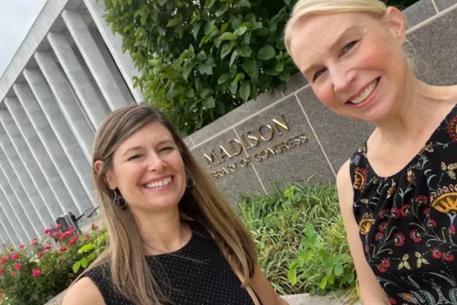 Two Life Span Institute researchers who are women stand in front of the Library of Congress for a photo