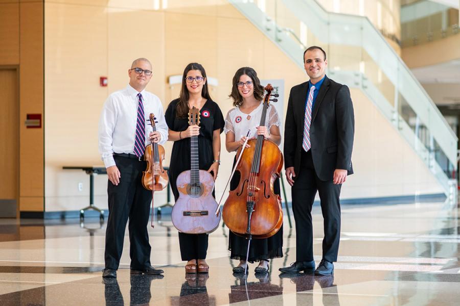 a group of people standing with instruments