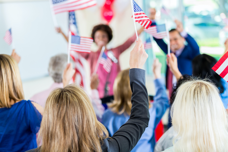 Istock image of candidates, American flags in crowd.