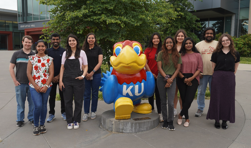 Eleven of KU's 2025-26 chemistry Summer Scholars with Jayhawk statue..