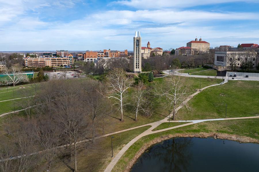 Spring view of KU Lawrence campus with Potter Lake in foreground, budding trees,