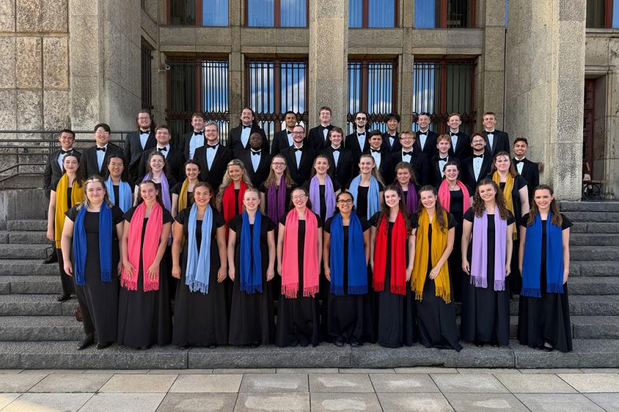 A group of musicians wearing robes standing on the stairs