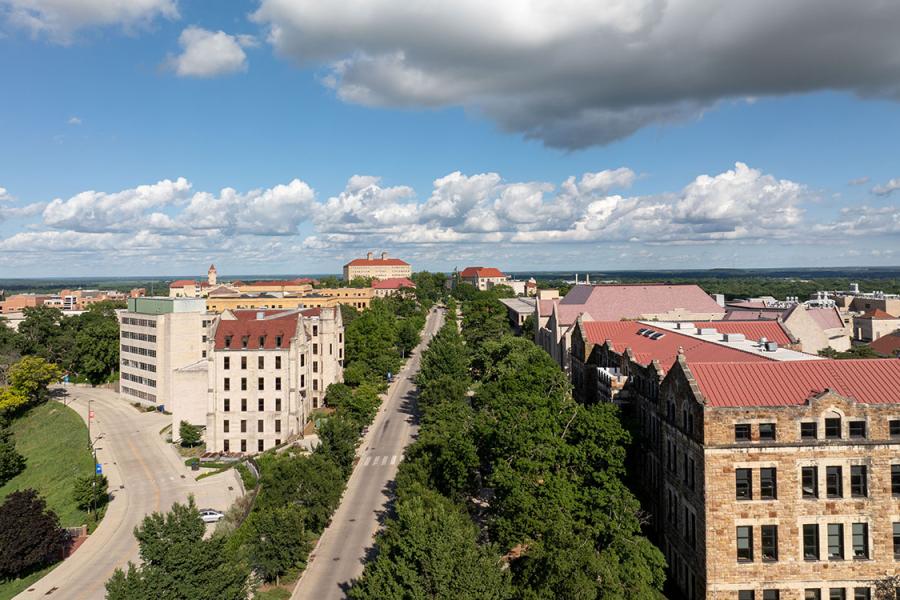 Spring view of Jayhawk Boulevard with Snow, Marvin halls in foreground. Clouds in sky.