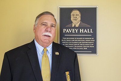 Retired KLETC Director Ed Pavey poses with his plaque