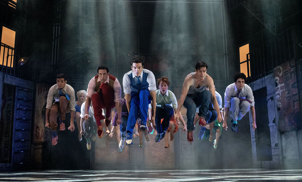 Leaping dancers pictured in a scene from the musical West Side Story.