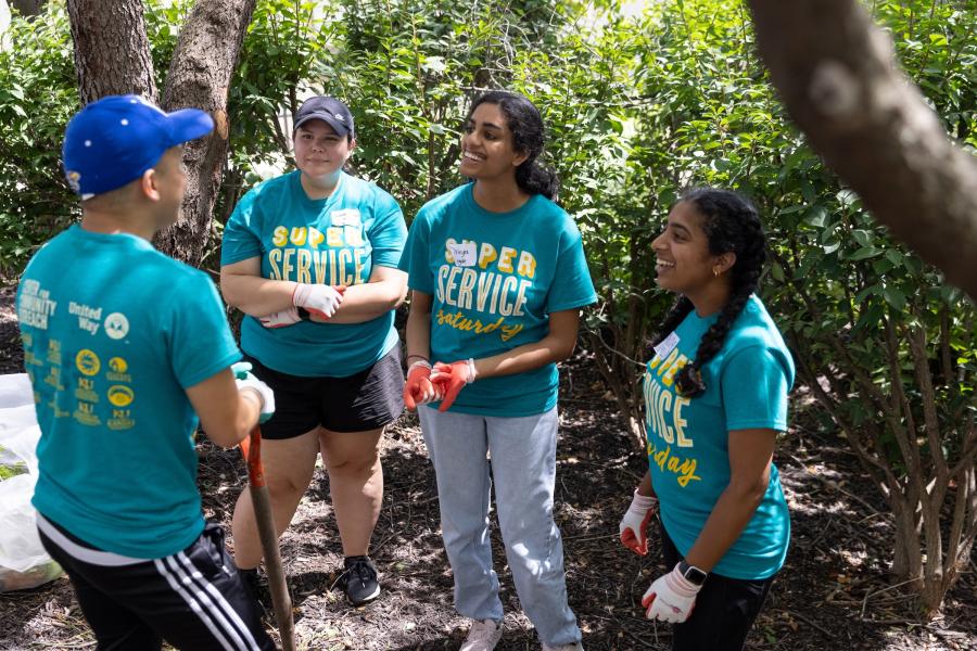 Super Service Saturday volunteers talking, smiling