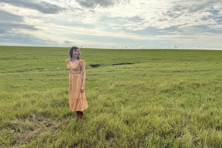 Megan Kaminski stands in prairie setting.
