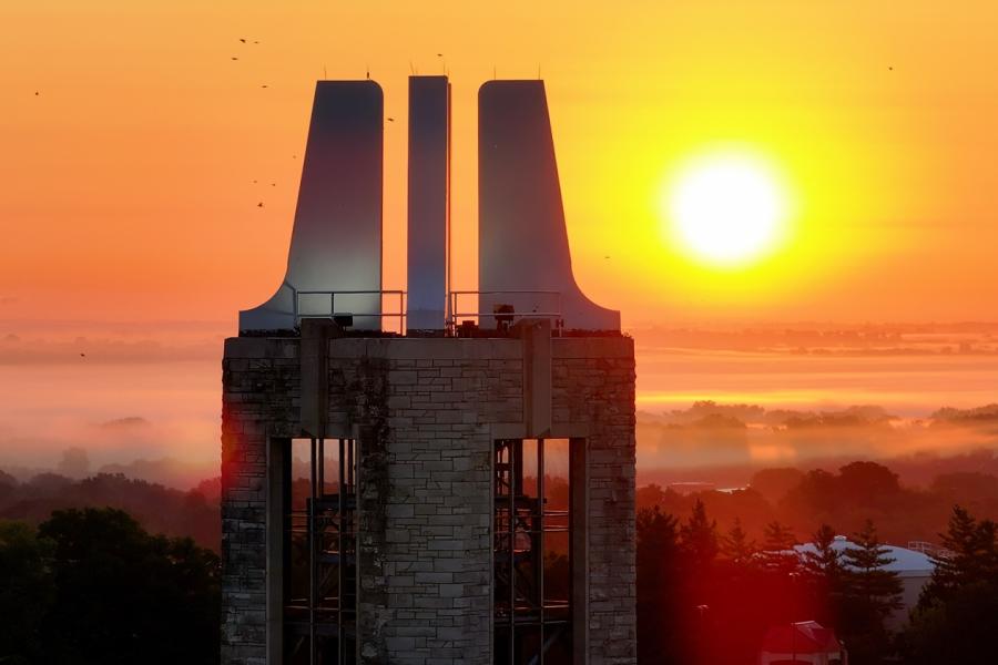 Aerial view of campanile on KU Lawrence campus during sunrise with fog