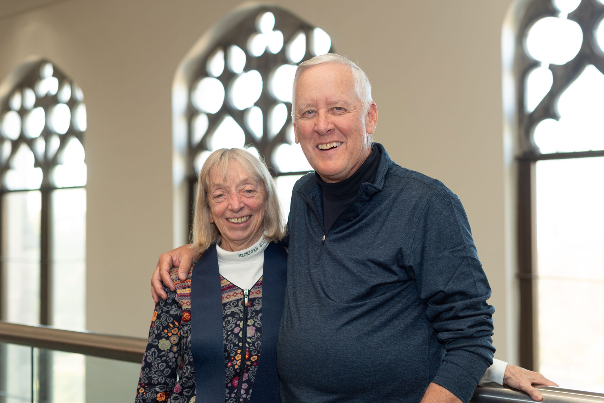 Cliff and Sue Haka in front of the Watson Library windows