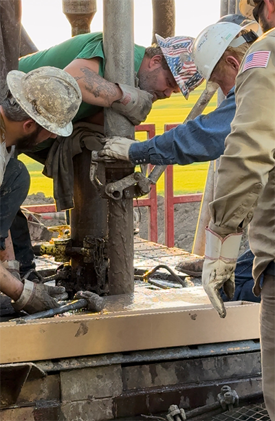 Crew members from Lighthouse Drilling, Kudu Coring, Mull Companies and the Kansas Geological Survey extract core from the Lyon County well.