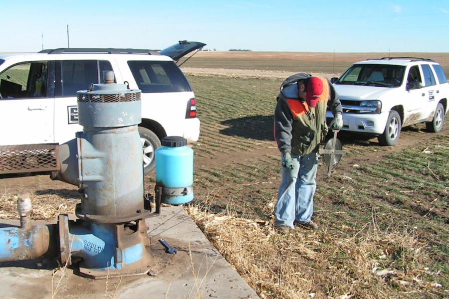 A KGS team member measures groundwater levels in a well in western Kansas