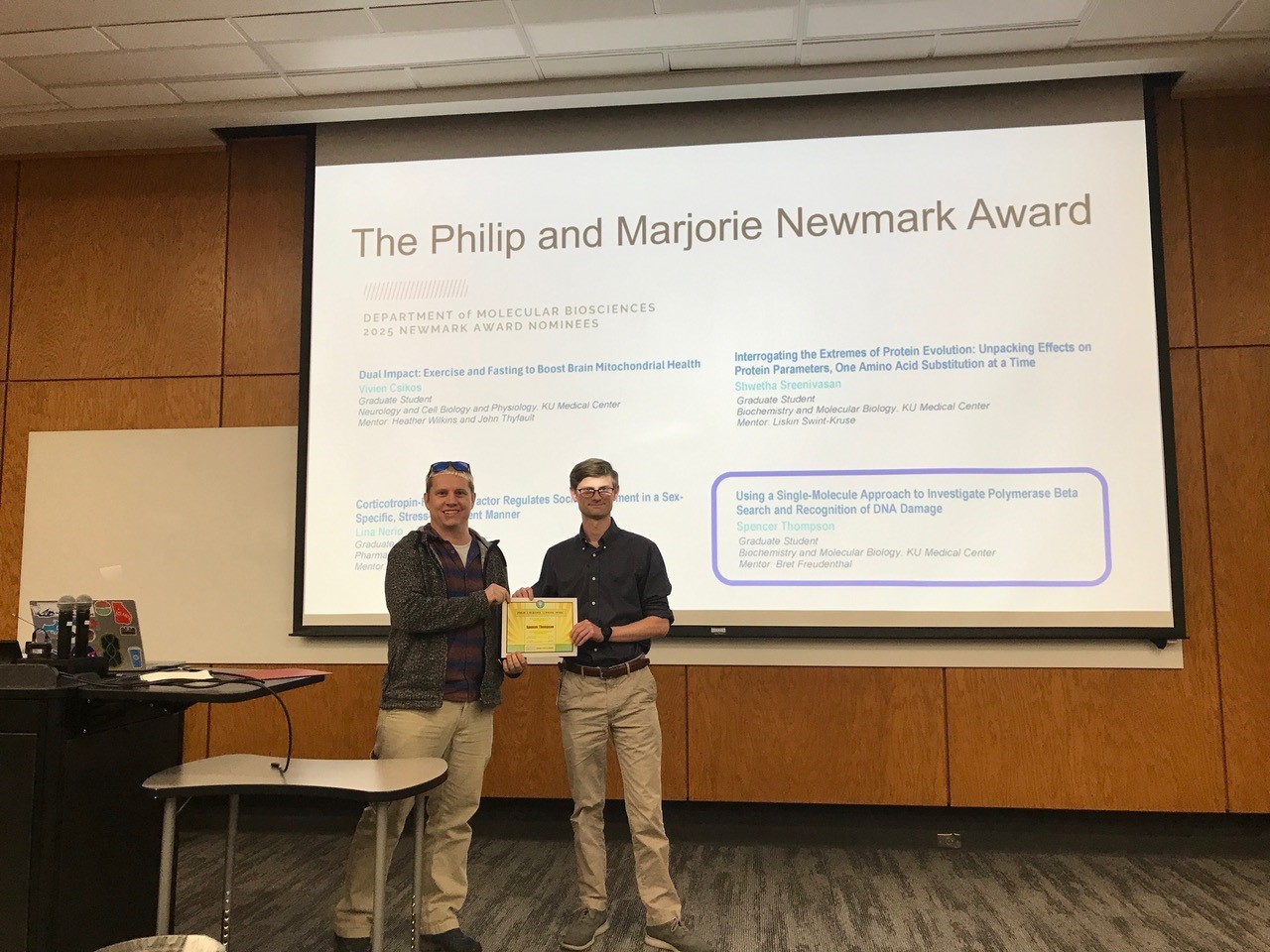 Spencer Thompson (right) receiving the Newmark Award from Erik Holmstrom (left)