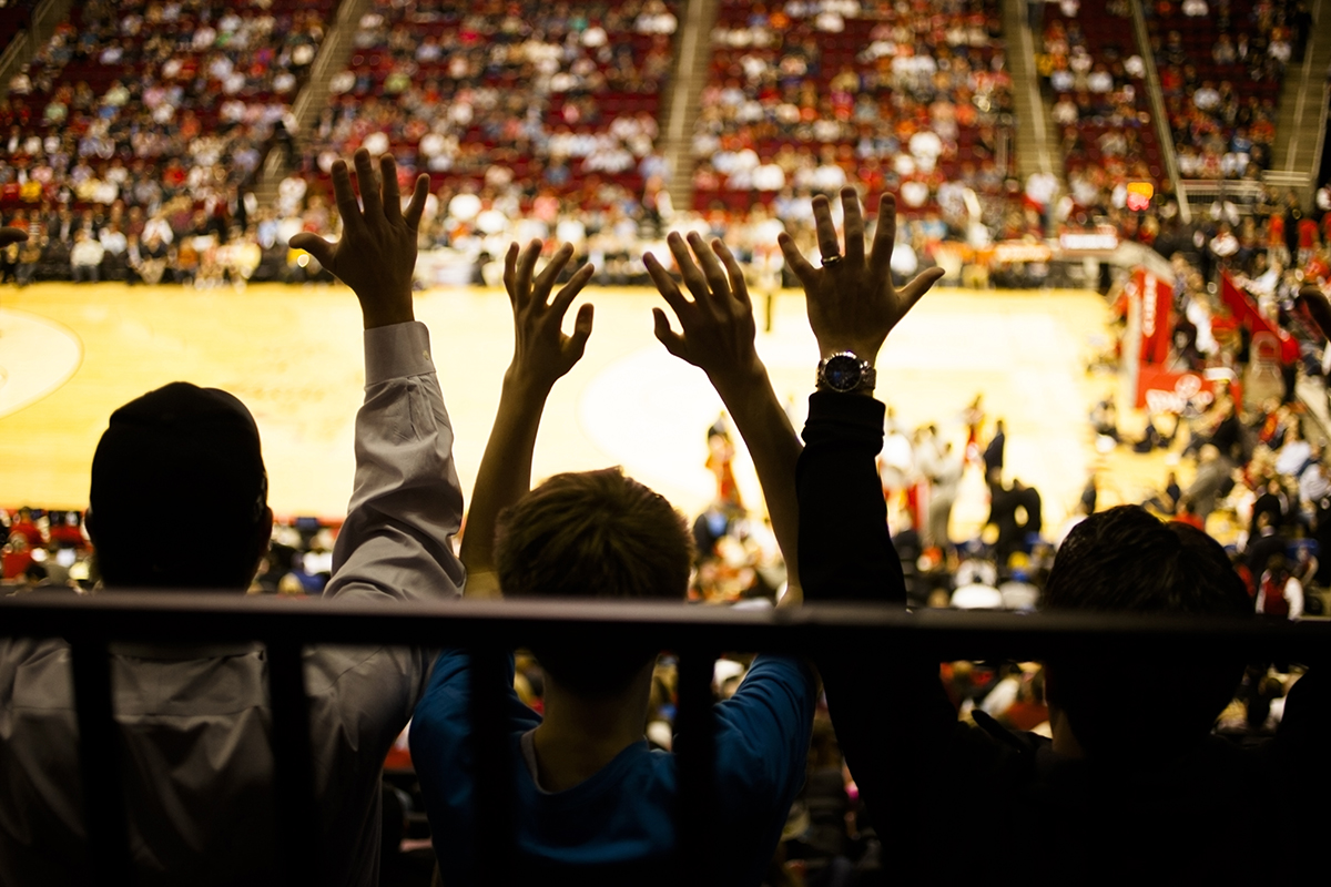 Fans watching basketball game in crowd