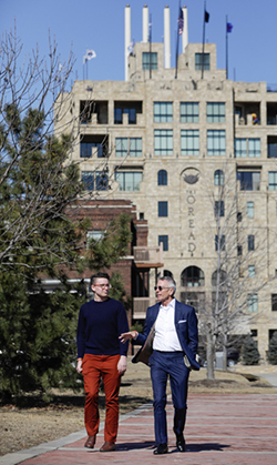 Sam Ritchie, a senior from Minneapolis, Kansas, and current recipient of the Chad A. Leat Student Scholarship, walks on campus with the KU alumnus.