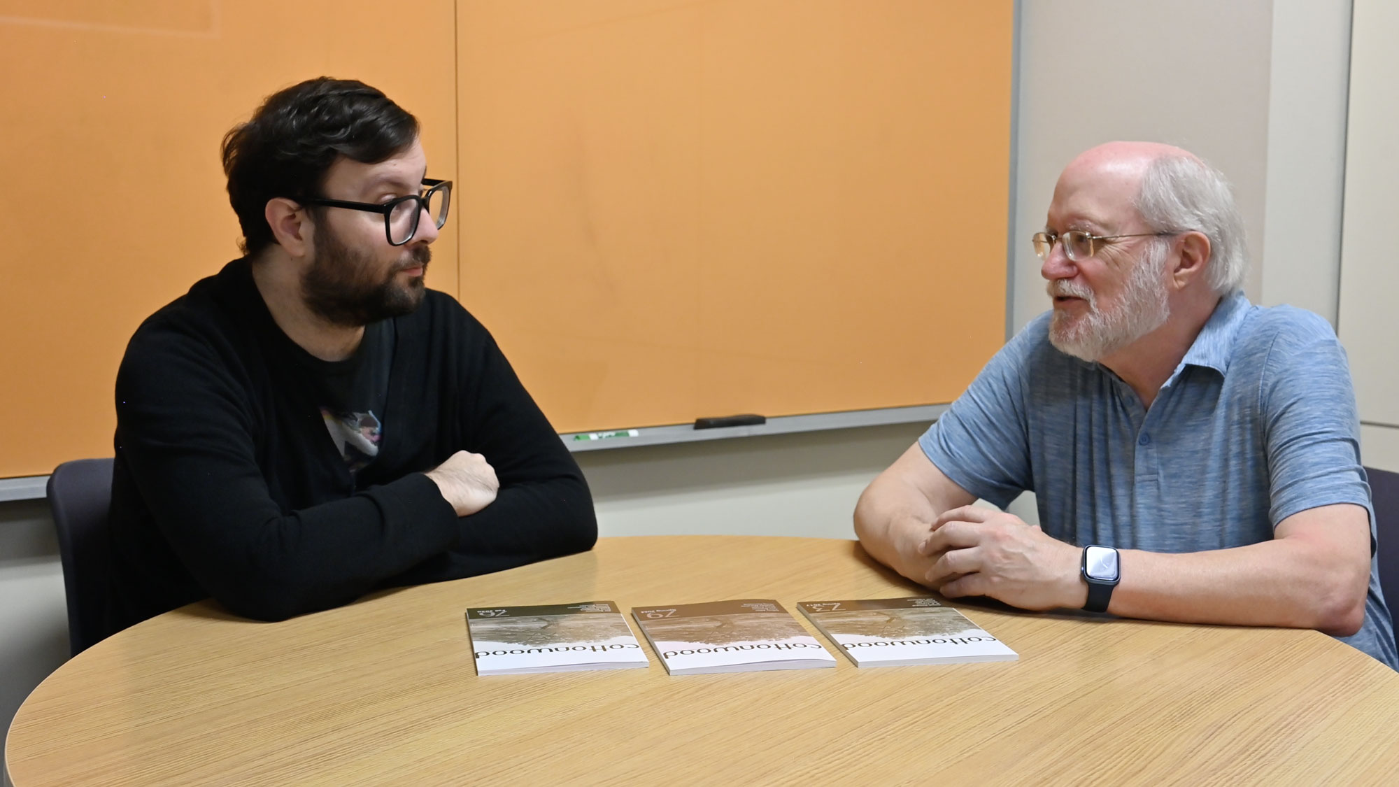 KU Libraries' Eric Bader and Cottonwood's Phil Wedge discuss a recent publication.