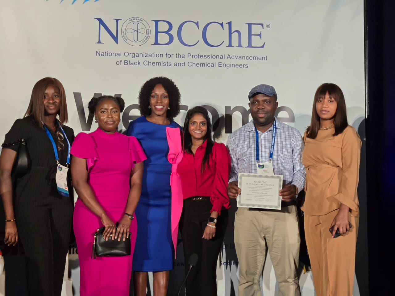 KU-NOBCChE members and the national organization's president on stage with the certificate of charter.