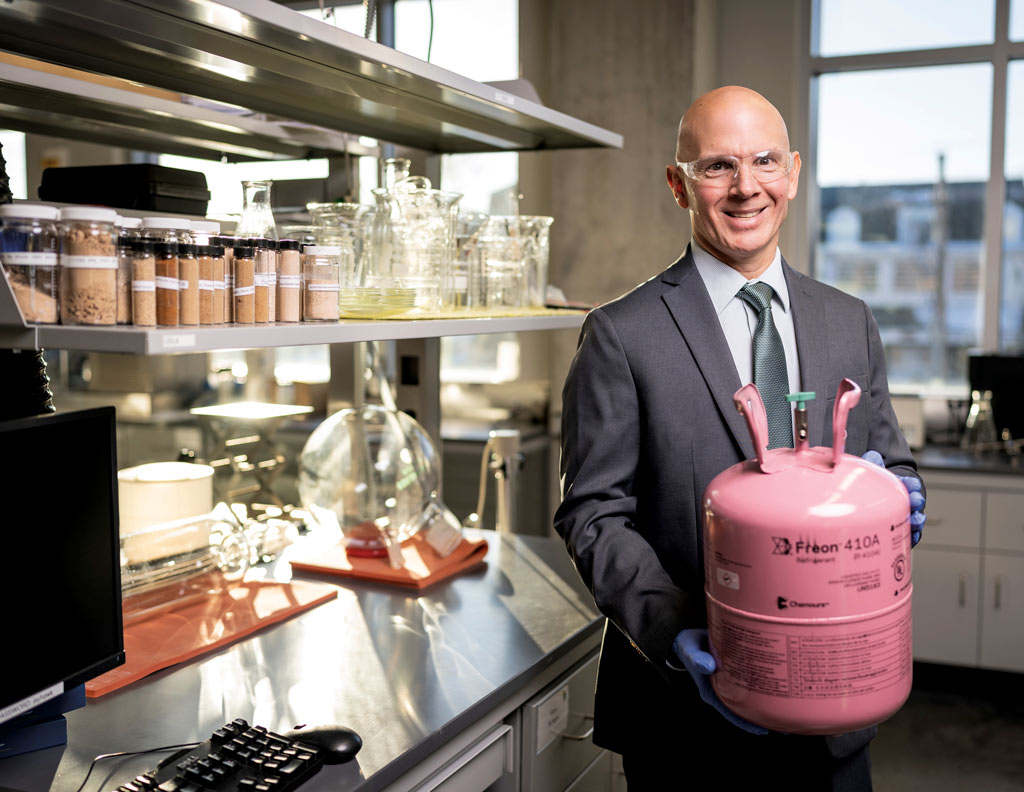 Mark Shiflett holding a tank of refrigerant